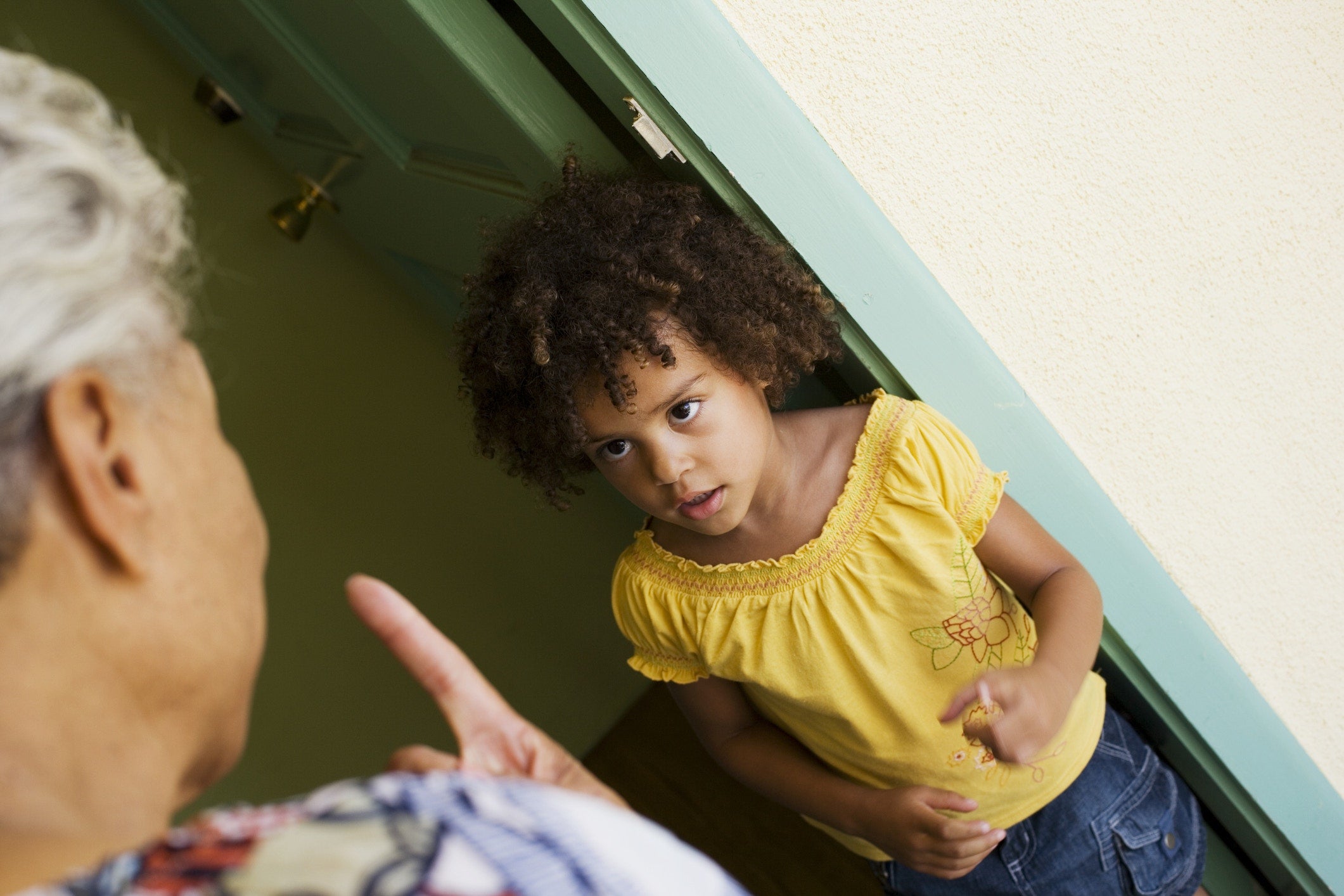 girl looking scared while her granny scolding her