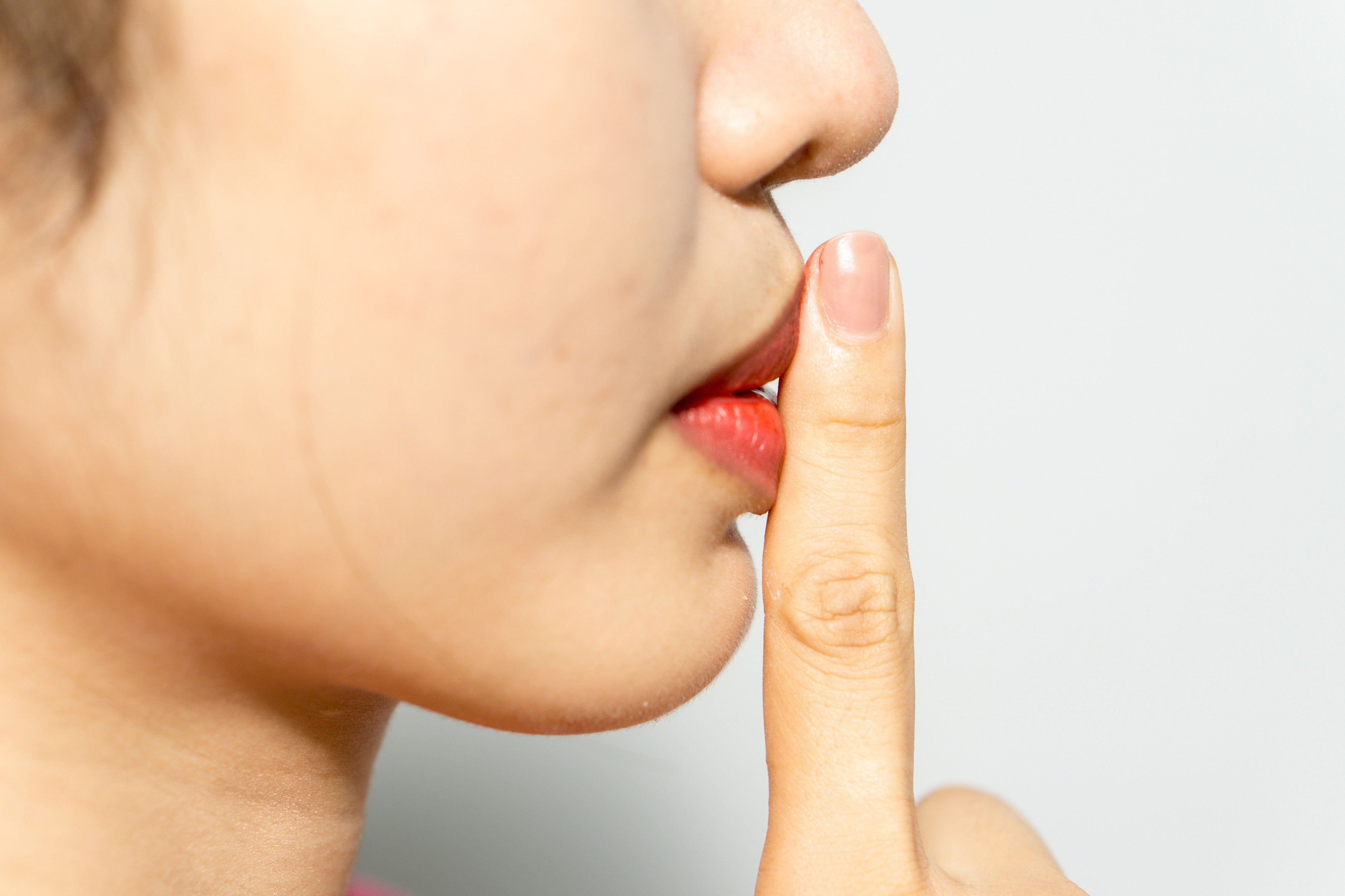 woman finger on lips