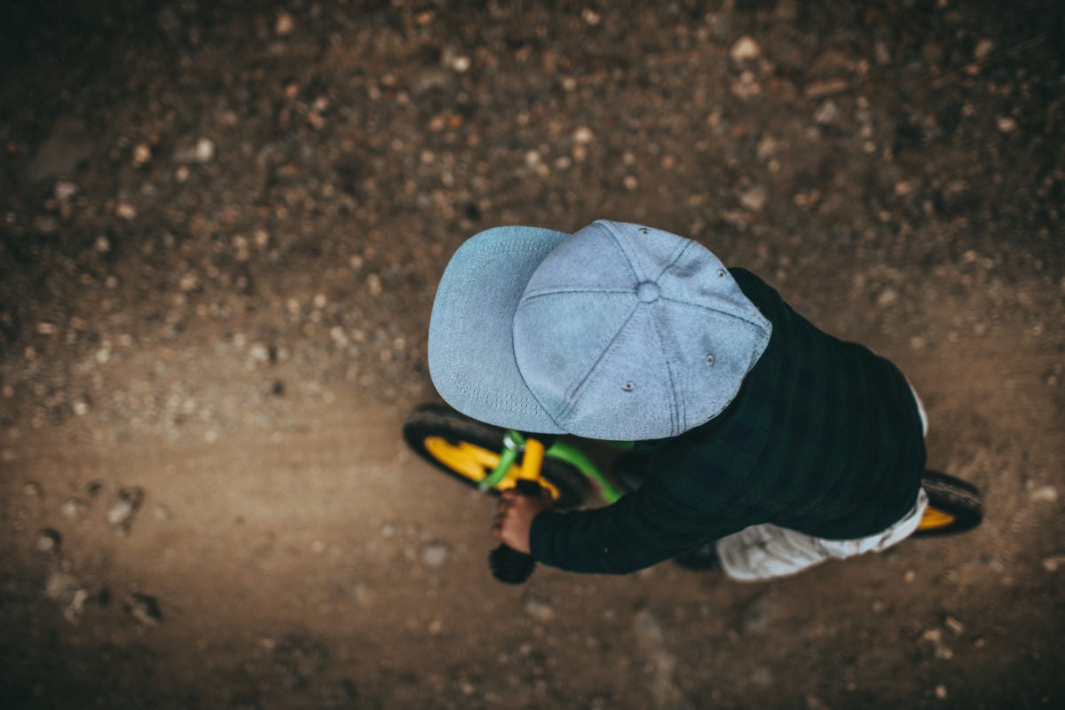 A kid is riding bicycle