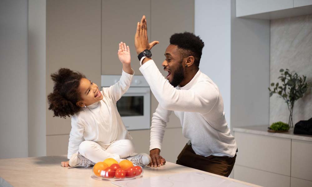 Dad and daughter high fiving