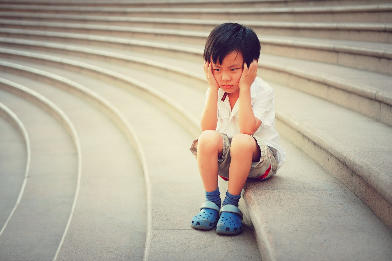 small child sitting on stairs