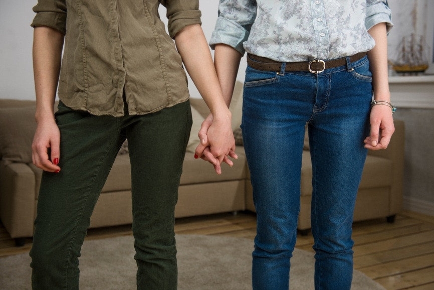 two women holding hands