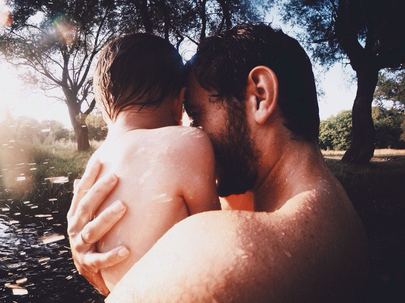 father and child playing in water