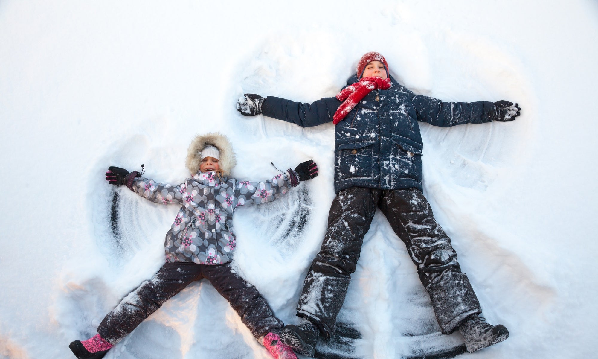 Two children playing in snow