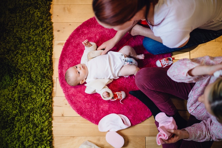  young mother plays with a baby