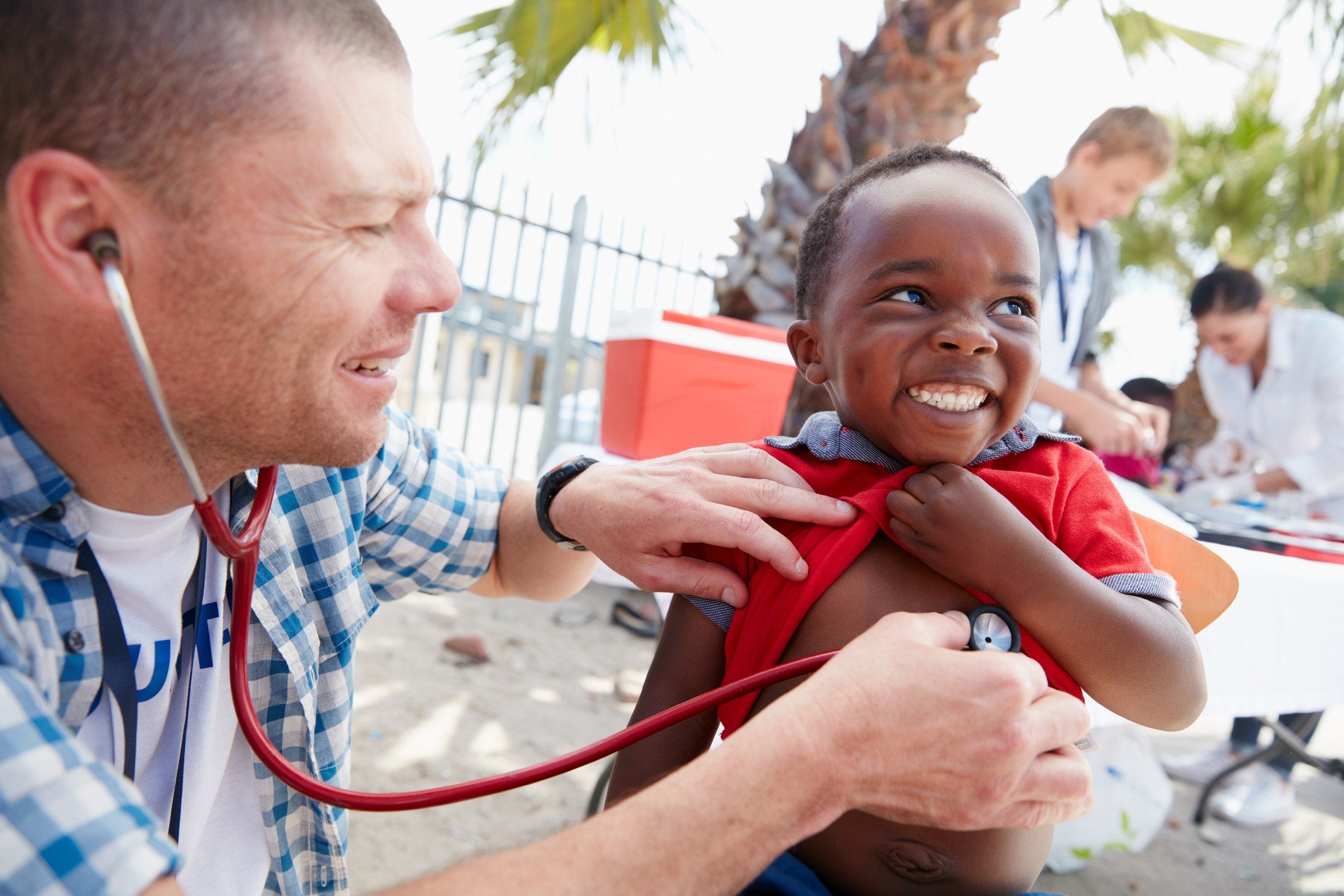 doctor checking little boy heartbeat