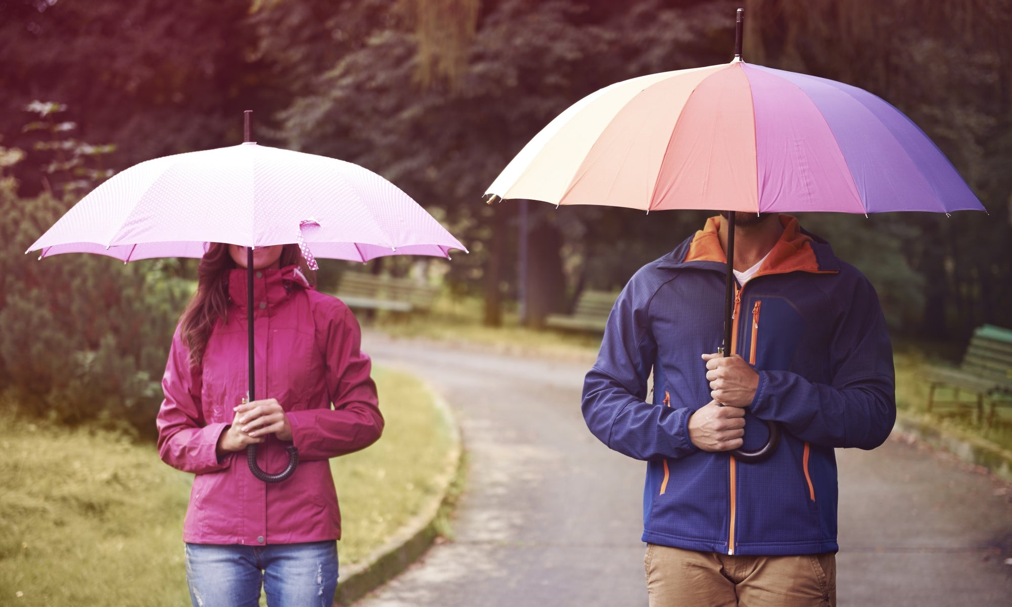 men and women covering face with an umbrella