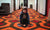 young boy on floor with various toys