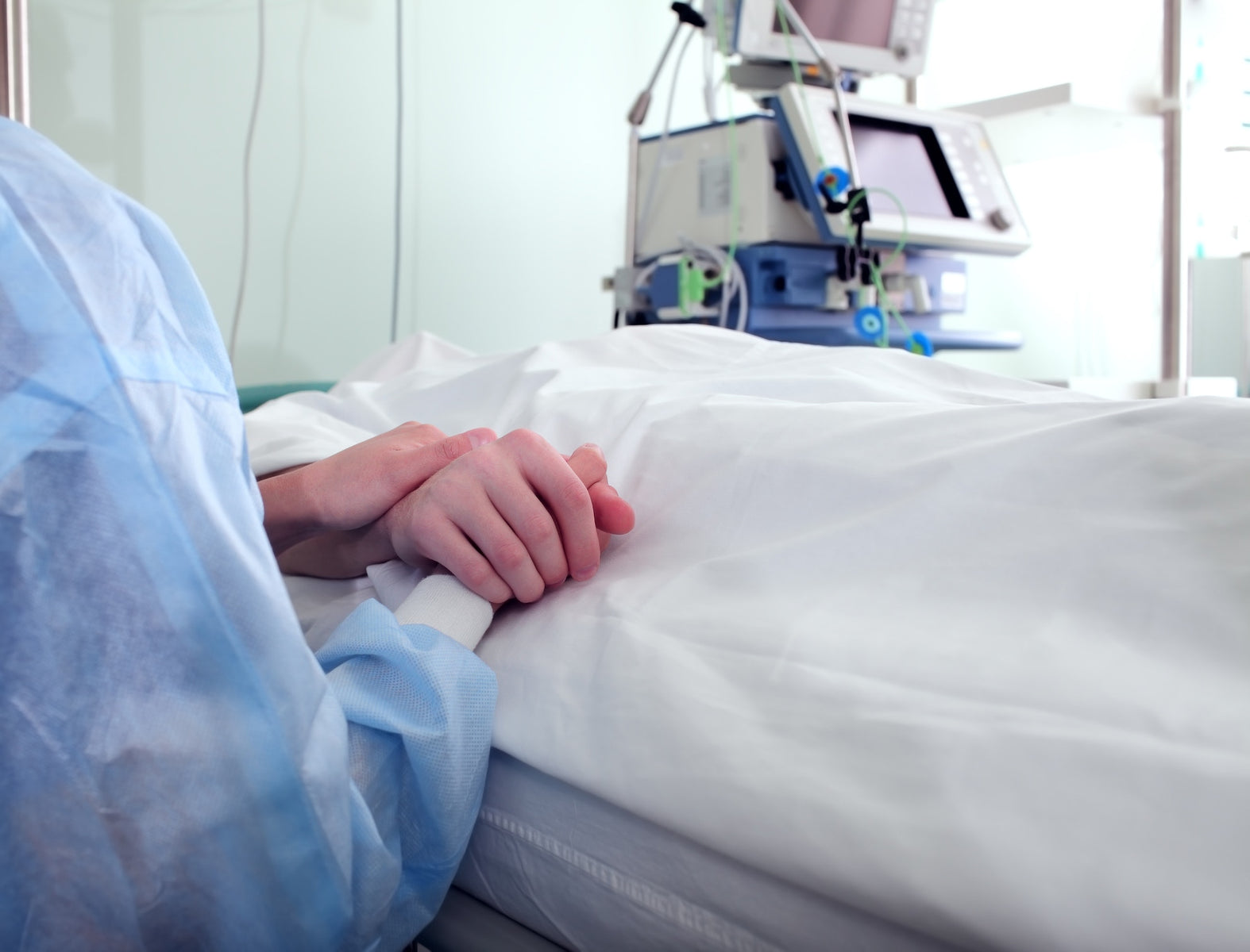 holding patient hand in the hospital room