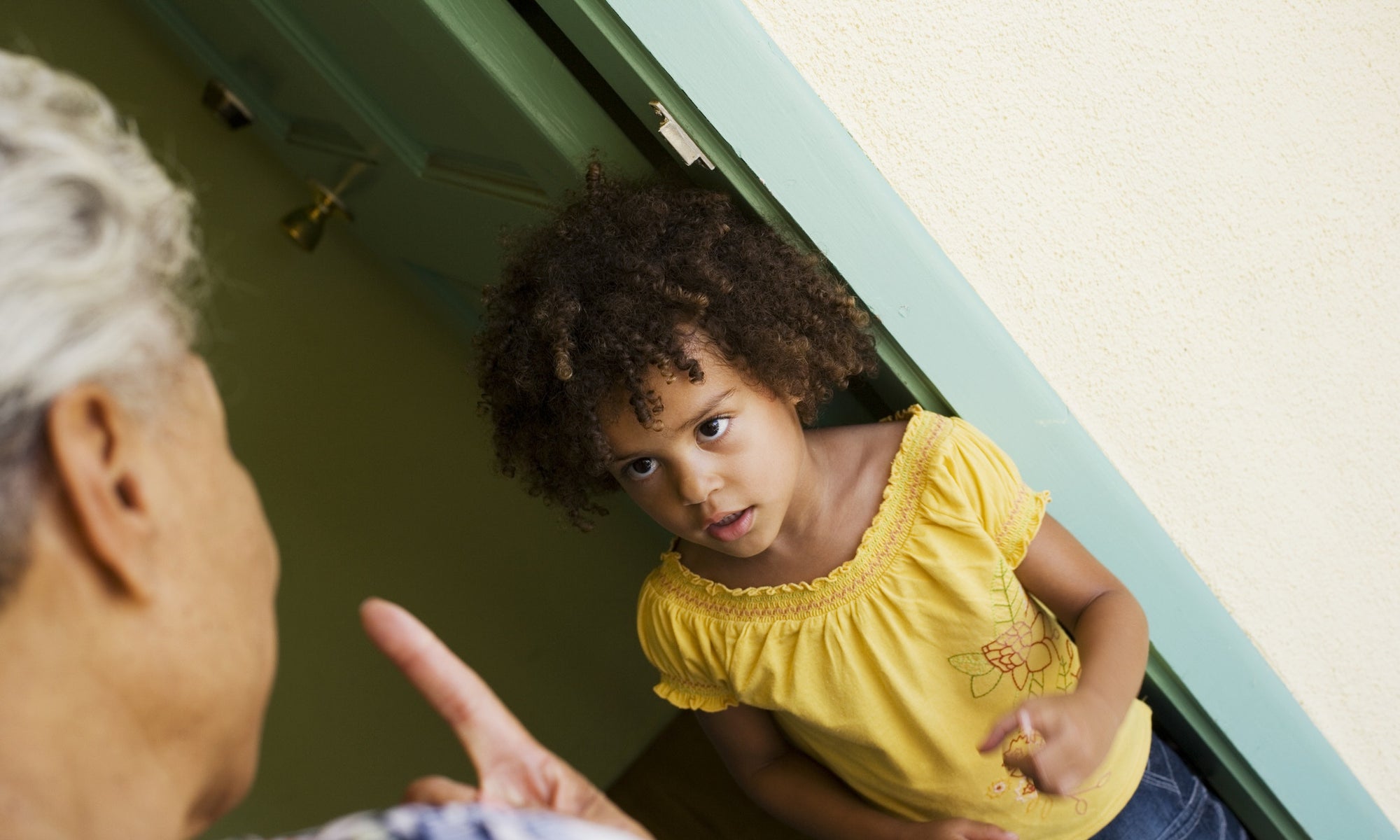 girl looking scared while her granny scolding her