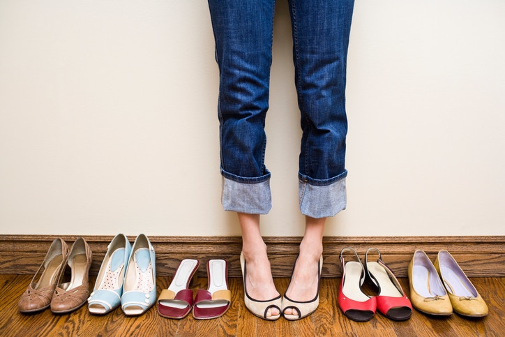 young woman trying on pair of sandals