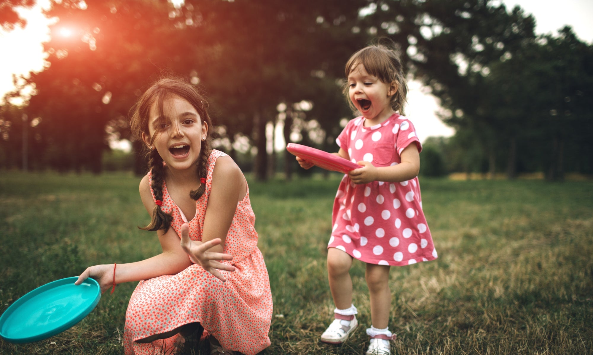 Little Girls Playing With Frisbee Toy Outdoor In Nature