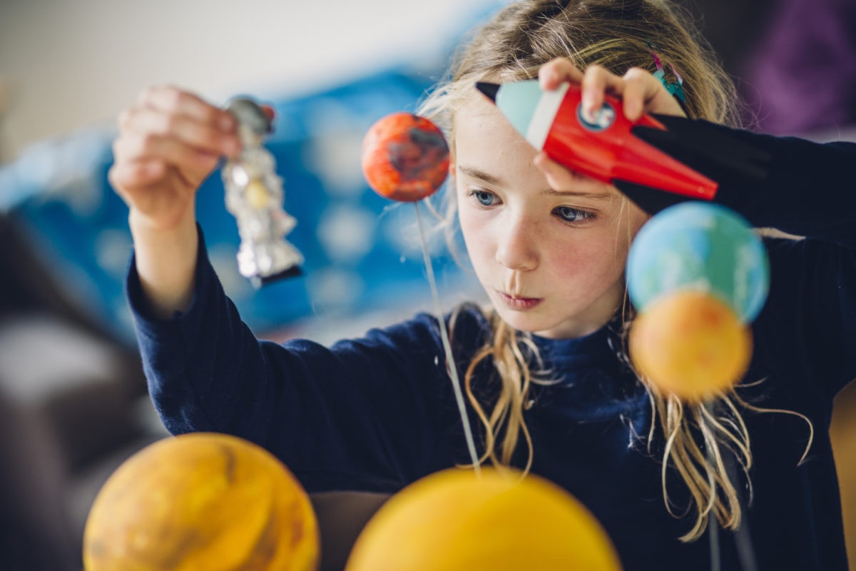 girl playing with baloons and minature toys