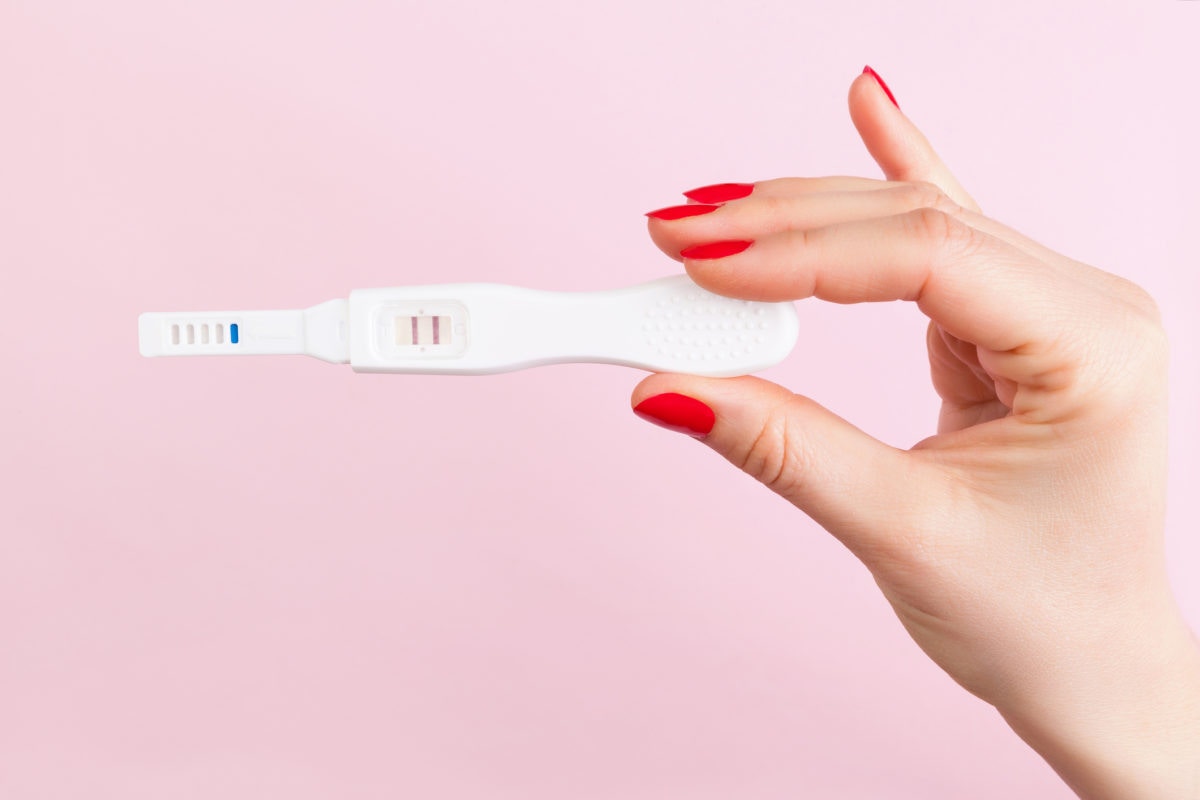  woman hand holding pregnancy test