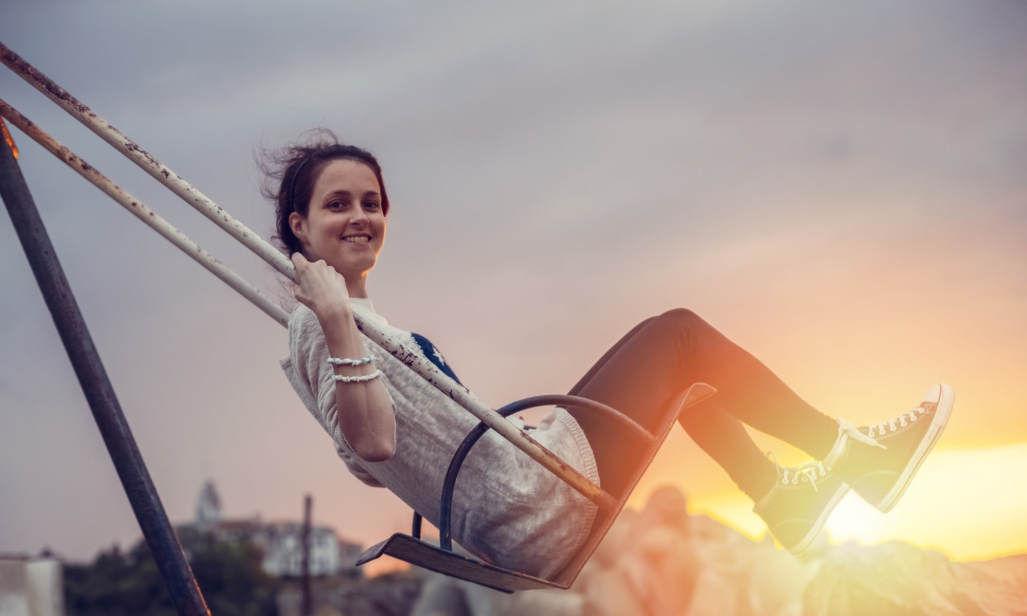 pretty girl swinging on a swing in a park