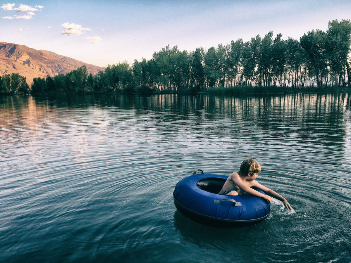 A boy on a lake in a ring floating