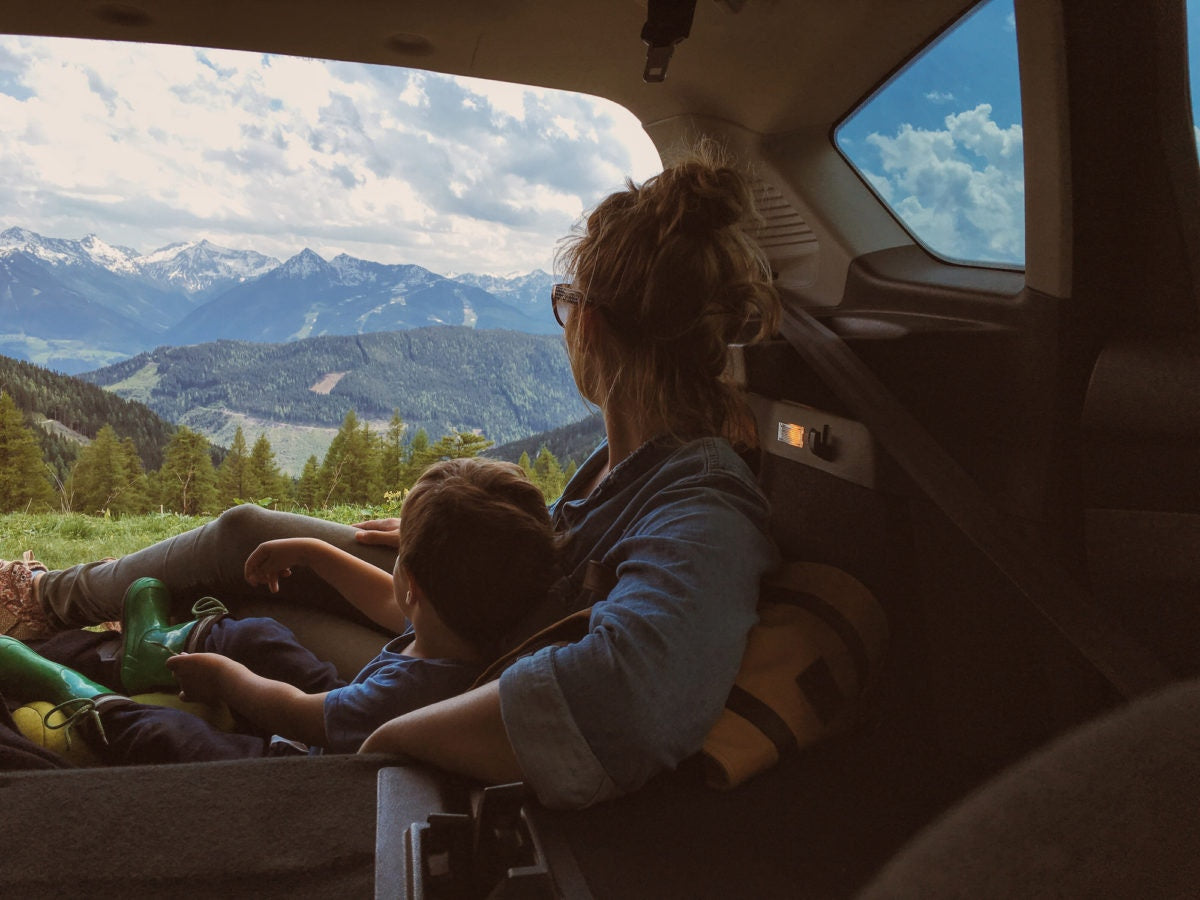 Family on a vacation to the hills on a car, view from inside car at the rear side