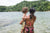Mother and a child is standing near river side wearing bikini