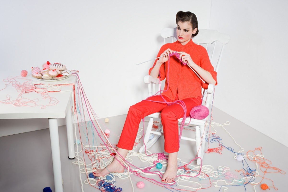 Young  Woman Knitting At Home