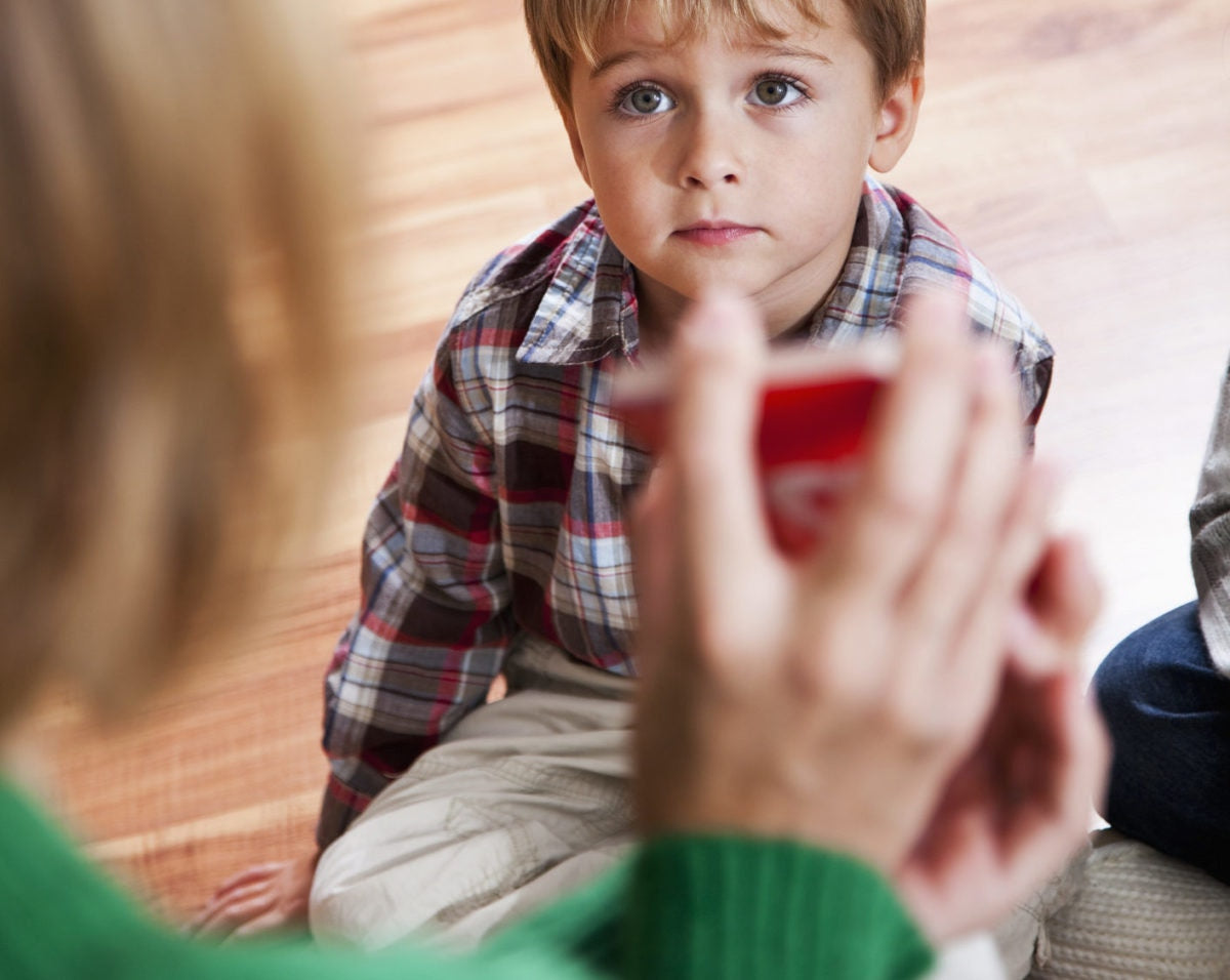 young boy looking at his teacher