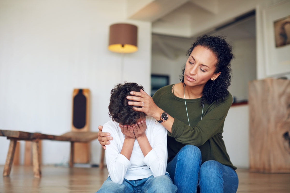 mother comforting crying son