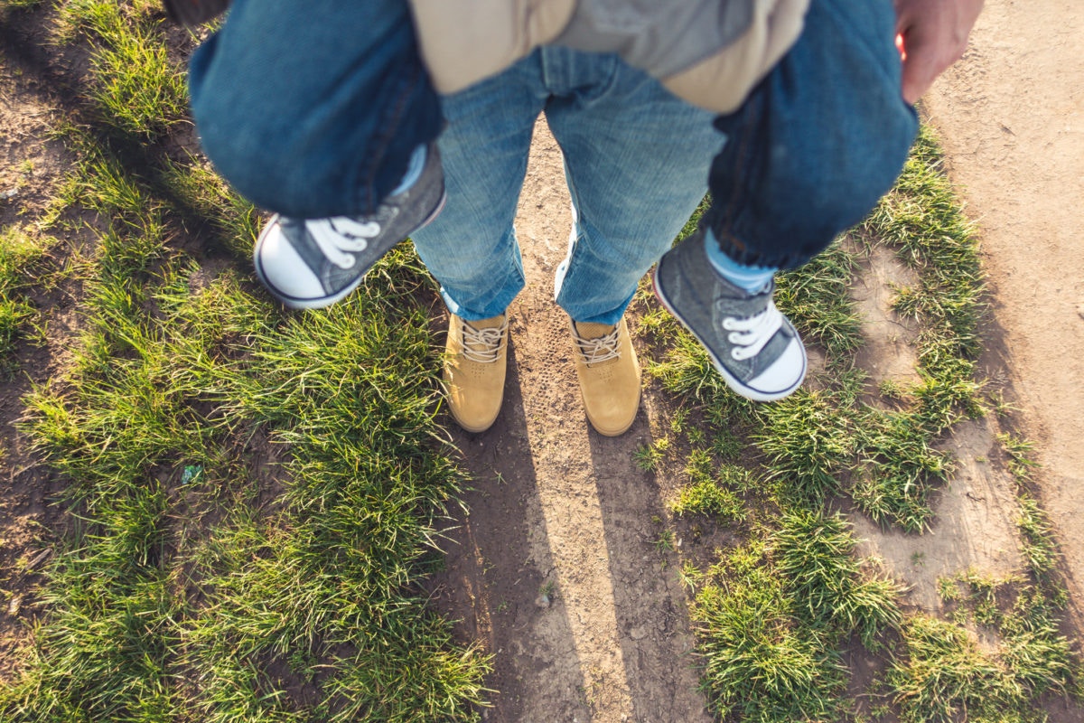 legs of father carrying baby