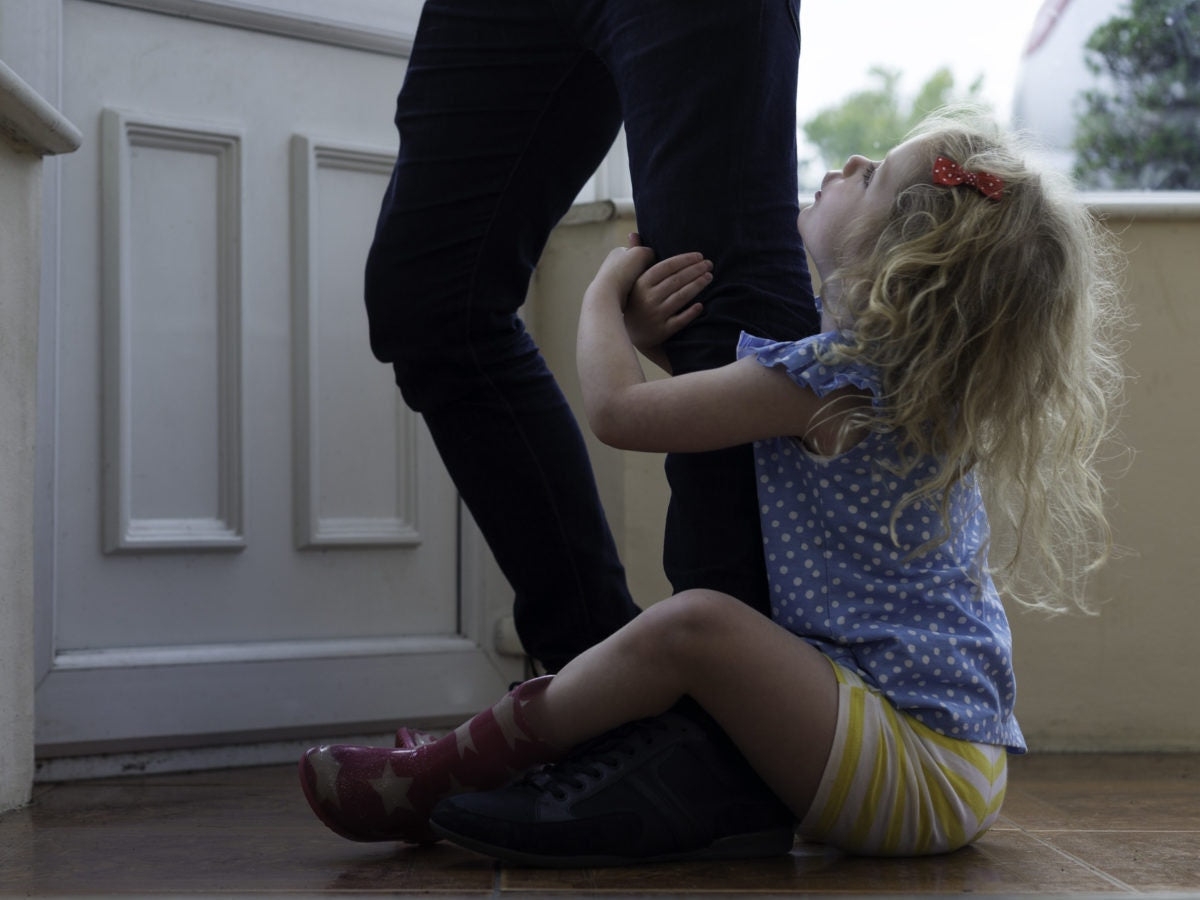 A child holding a persons leg