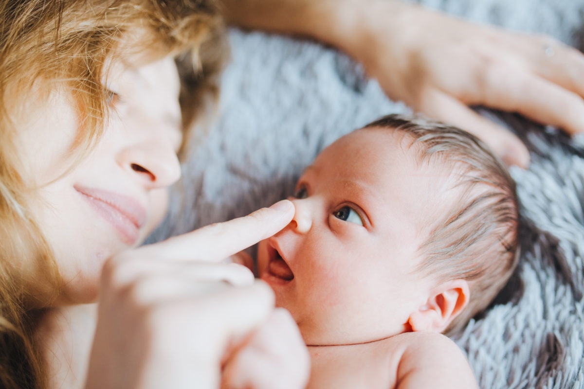 happy mother touching newborn baby's nose