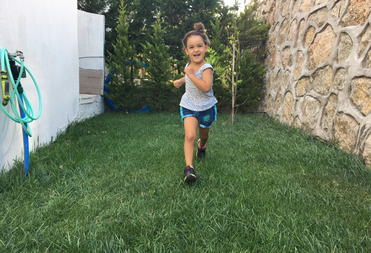 A Child running in grass