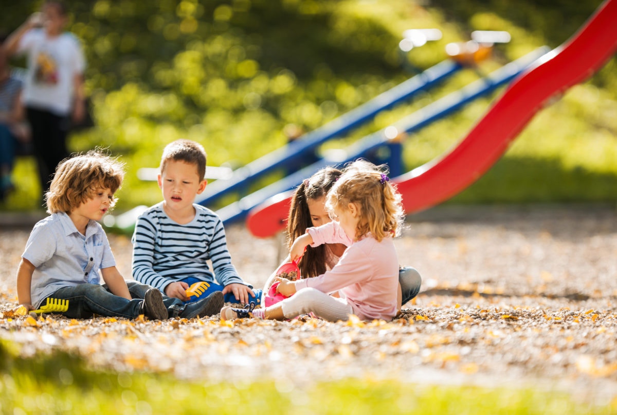 children sitting in the park and playing