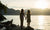 sisters holding hands looking at the lake