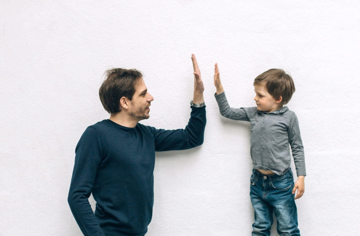 young father his little son giving high five