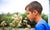 boy smelling white dandelion