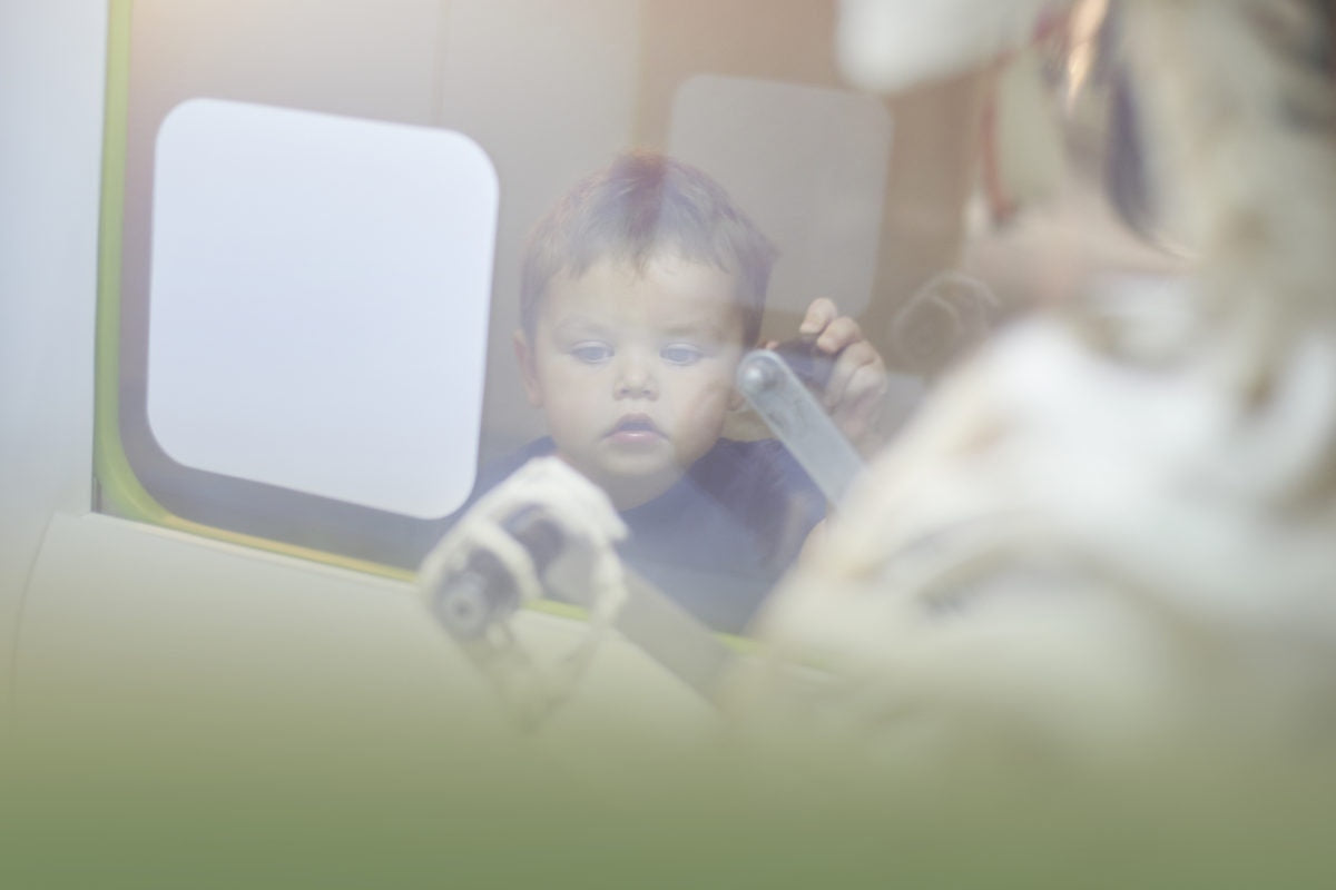 curious little boy looking out of the window