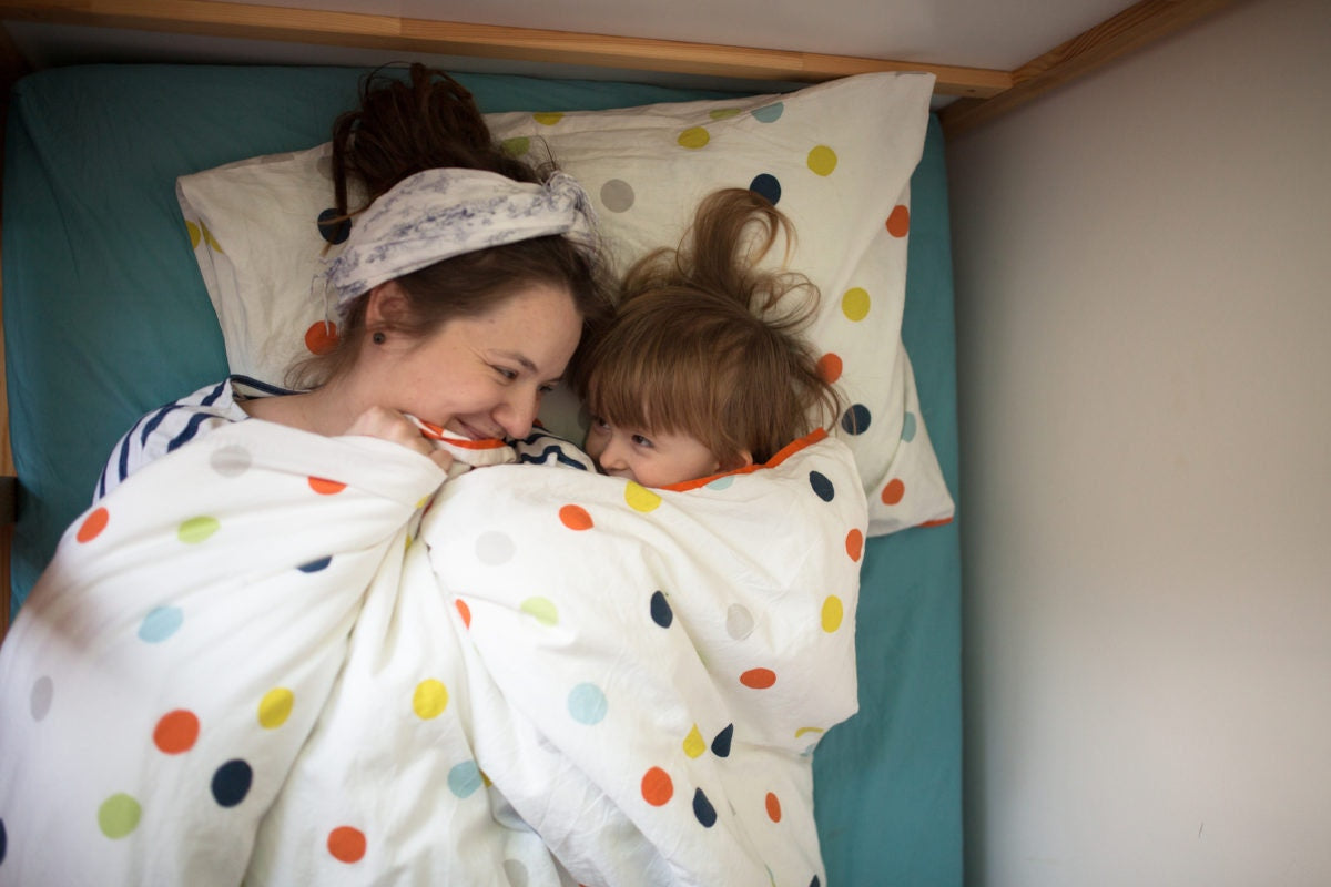 mother and child in bed looking at each other