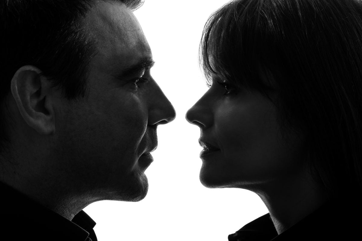 man and woman looking at each other at a very close distance