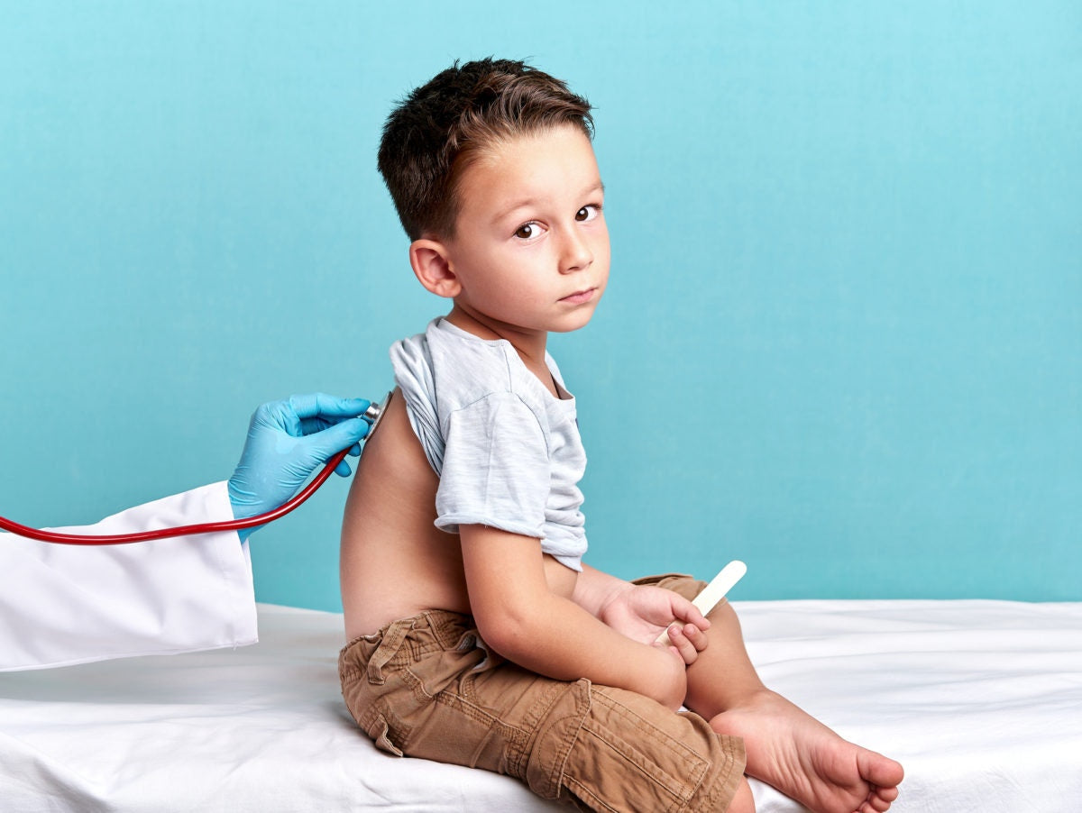 Doctor checking a kid with stethoscope