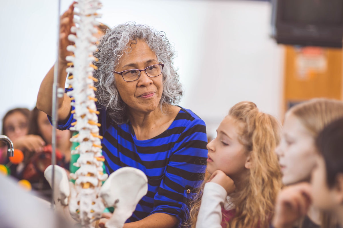 female elementary teacher teaching students about the human body