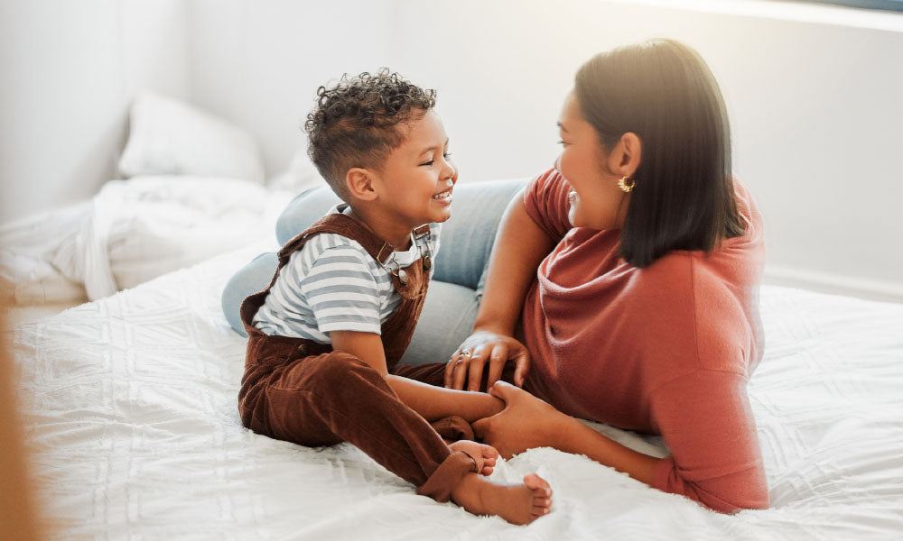 baby smiling at mother