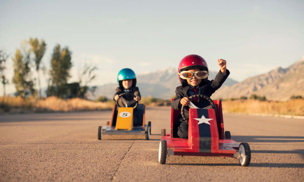 two boys playing in go carts