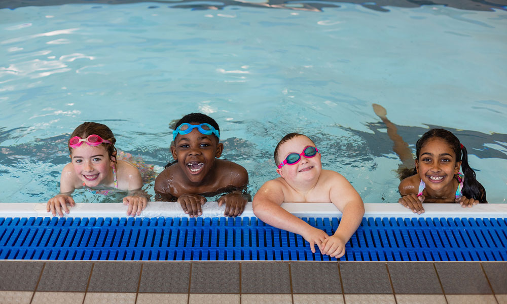 kid is enjoying their moment in a pool