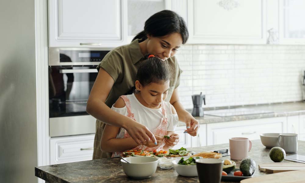 mother and daughter cooking