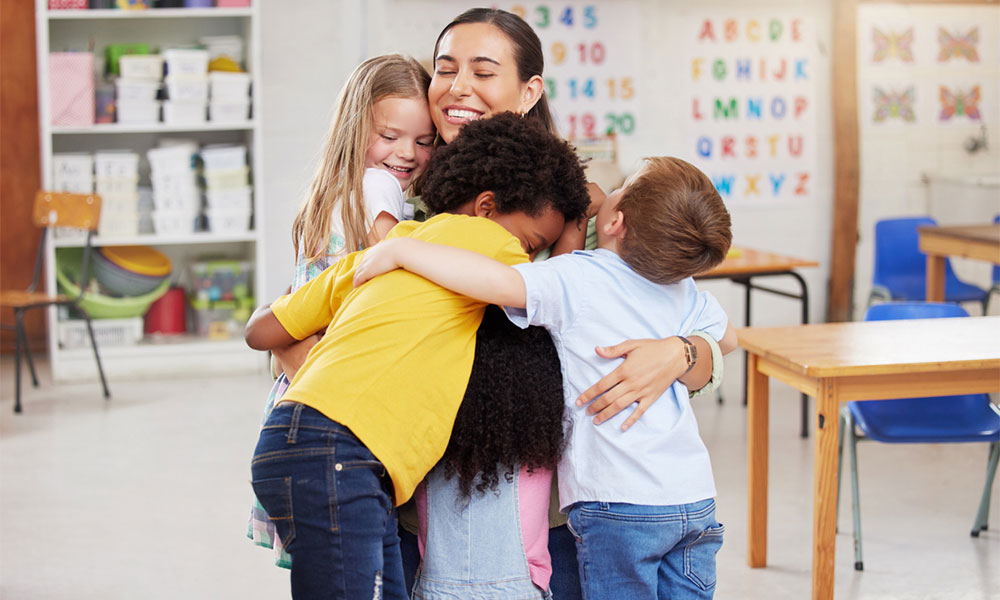 teacher hugging her students