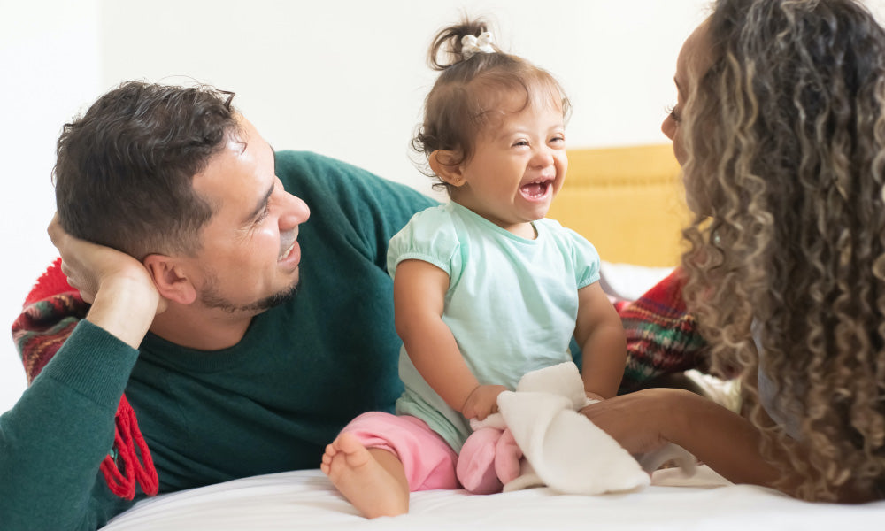 two adults and one kid laughing