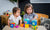 young girl and boy playing with abc block toys
